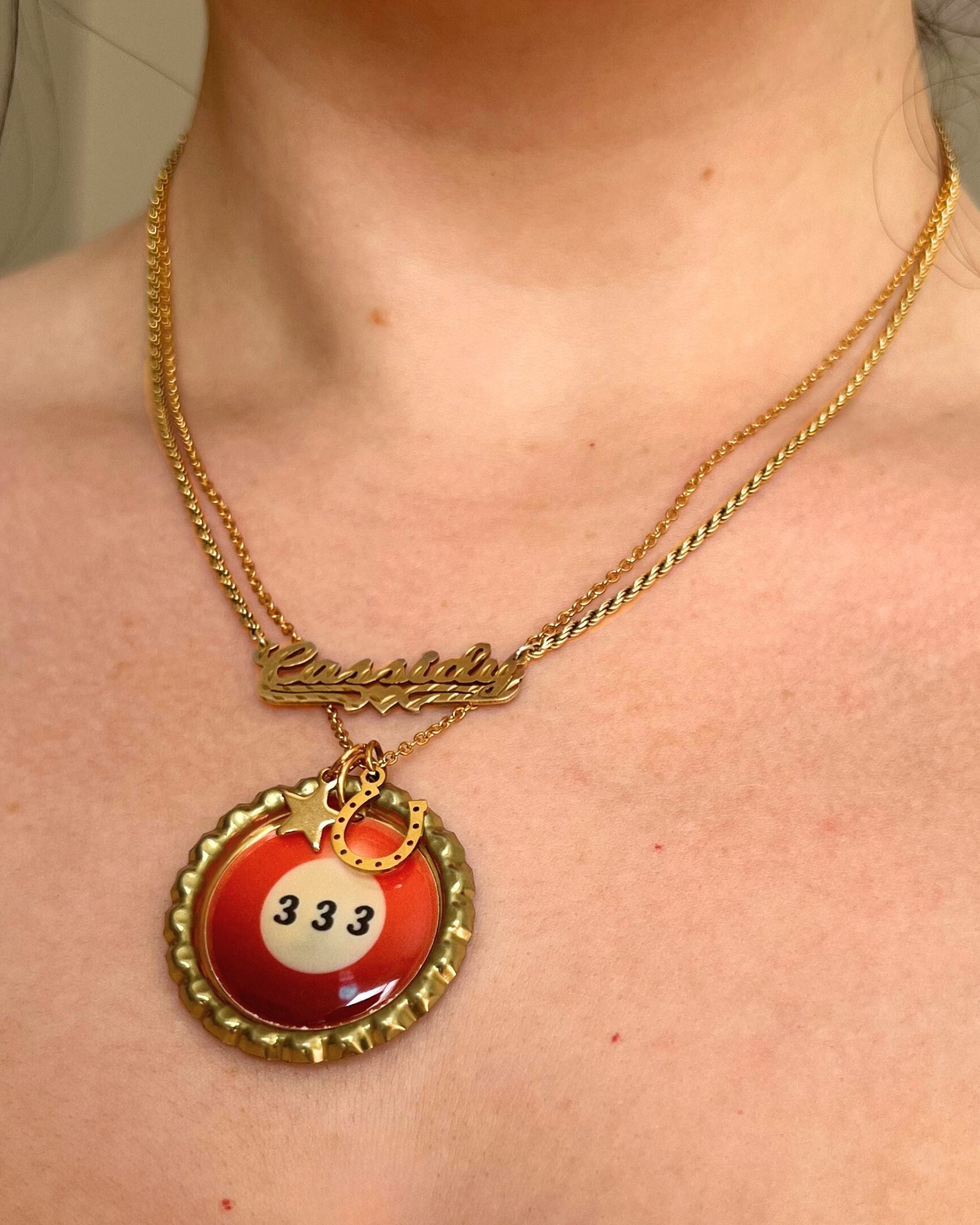 Necklace with a red and gold pendant worn by a person