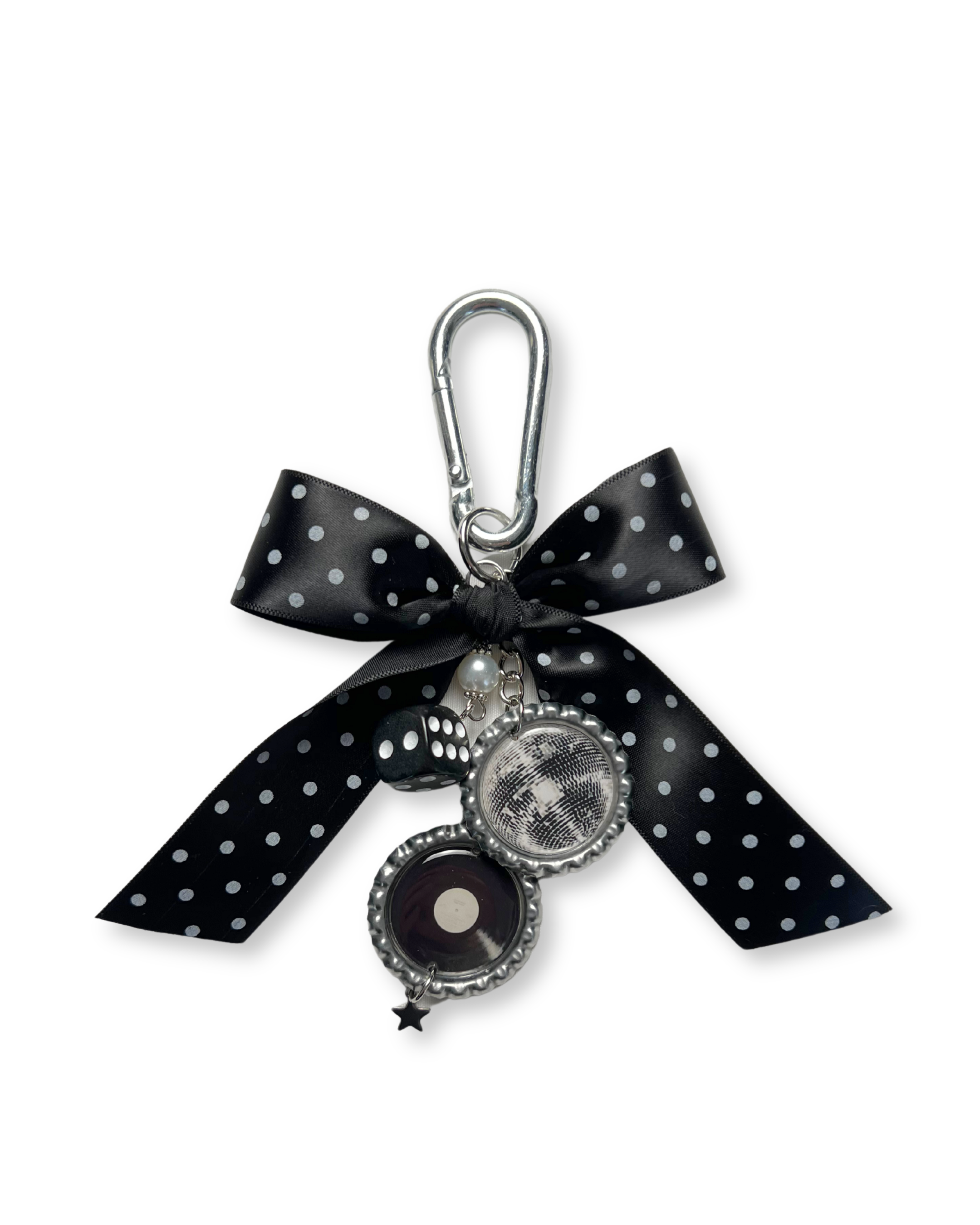 A black and silver handcrafted bag charm featuring a polka dot bow and various charms, attached to a stainless steel carabiner hook.