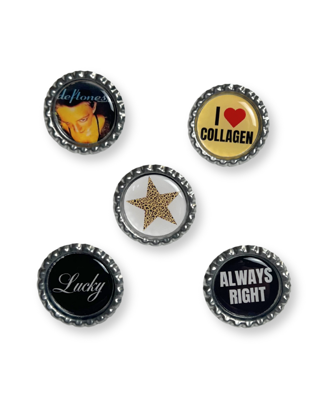 Set of five bottle cap pins with various designs on a white background