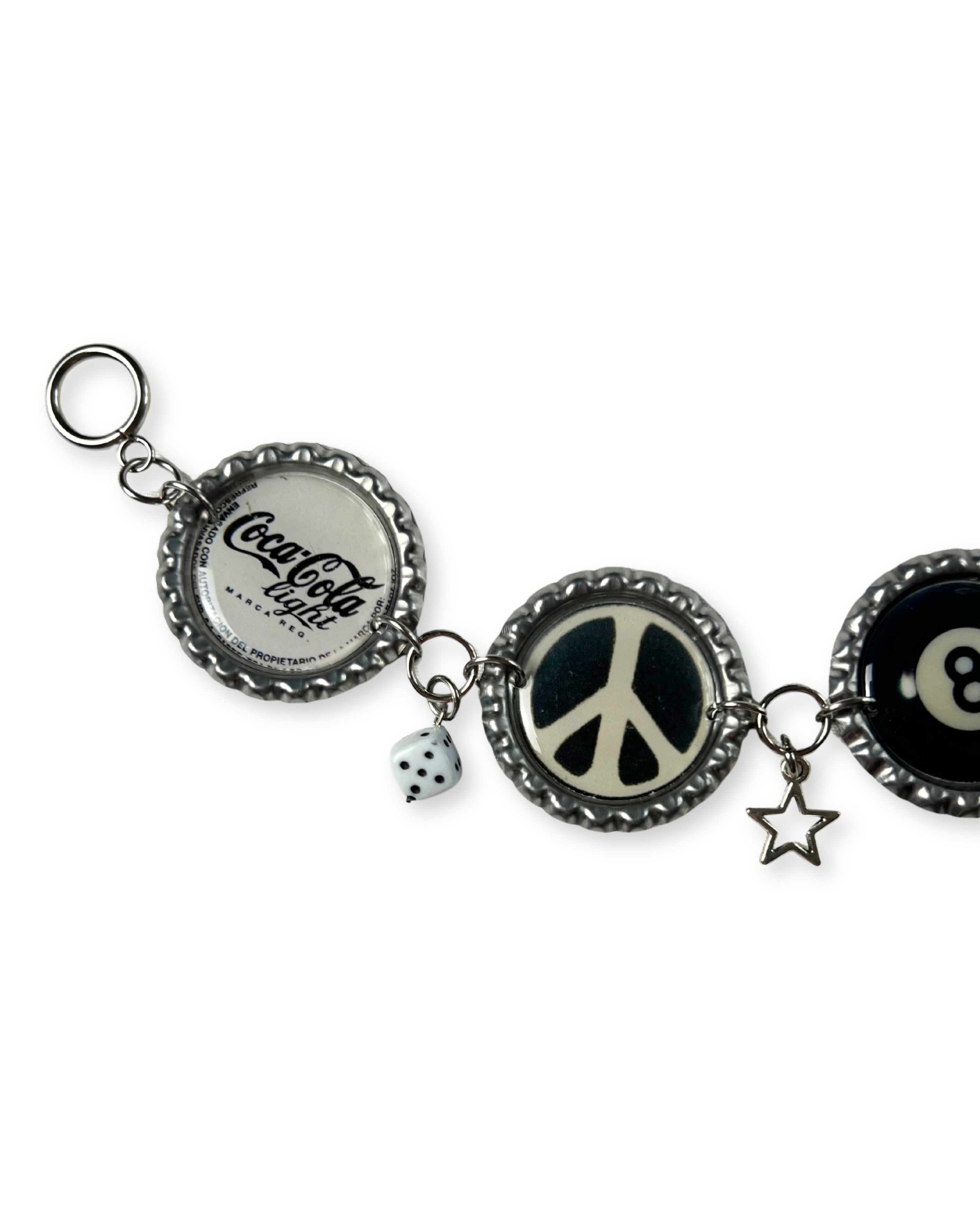 Keychain with bottle cap charms including a peace symbol, dice, and question mark on a white background.