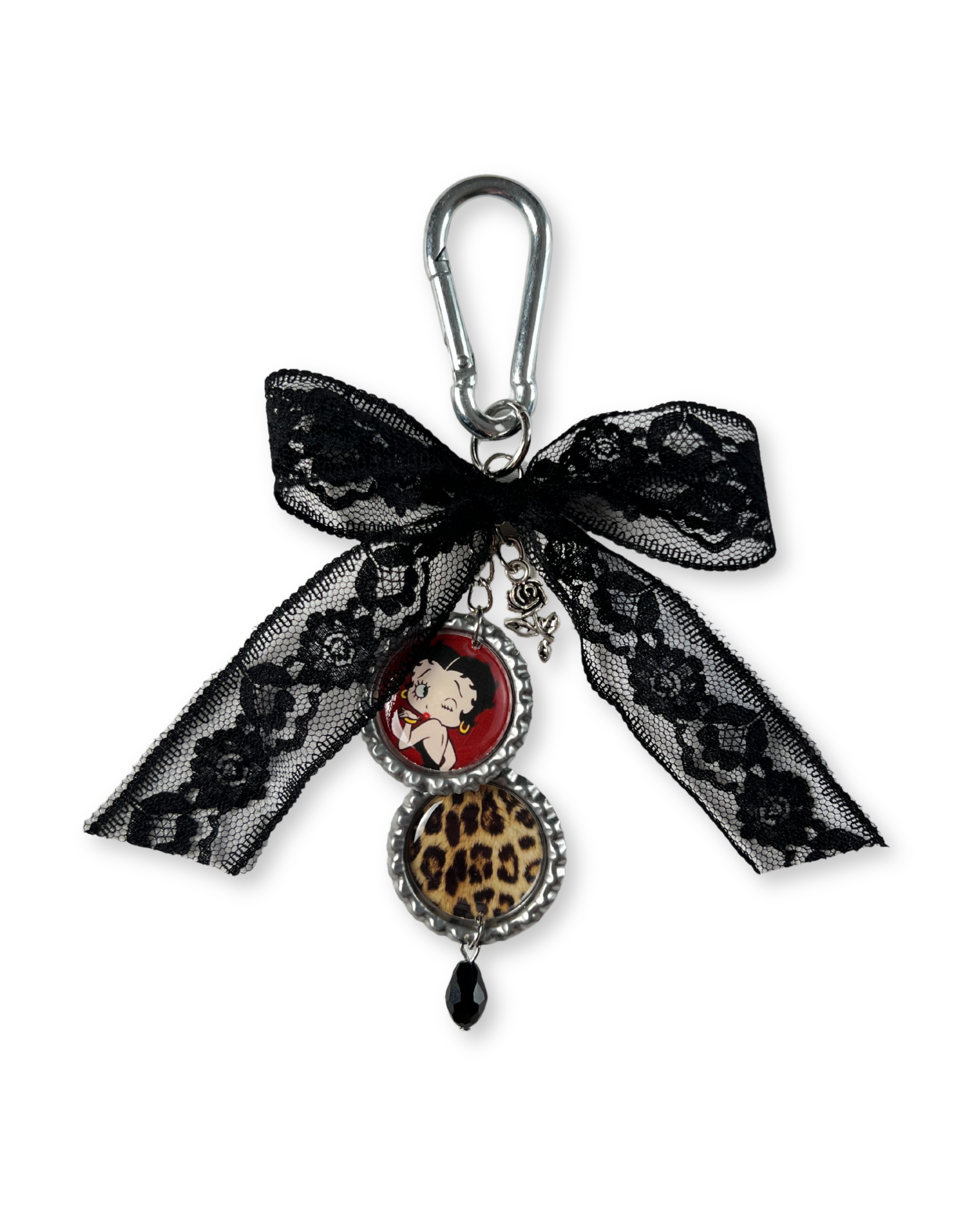 Keychain with black lace bow, leopard print charm, and red character on a white background