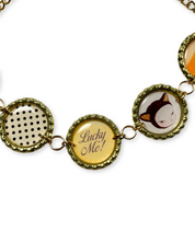 Bracelet with circular charms featuring different designs on a white background