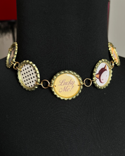 Necklace with bottle cap pendants on a black mannequin