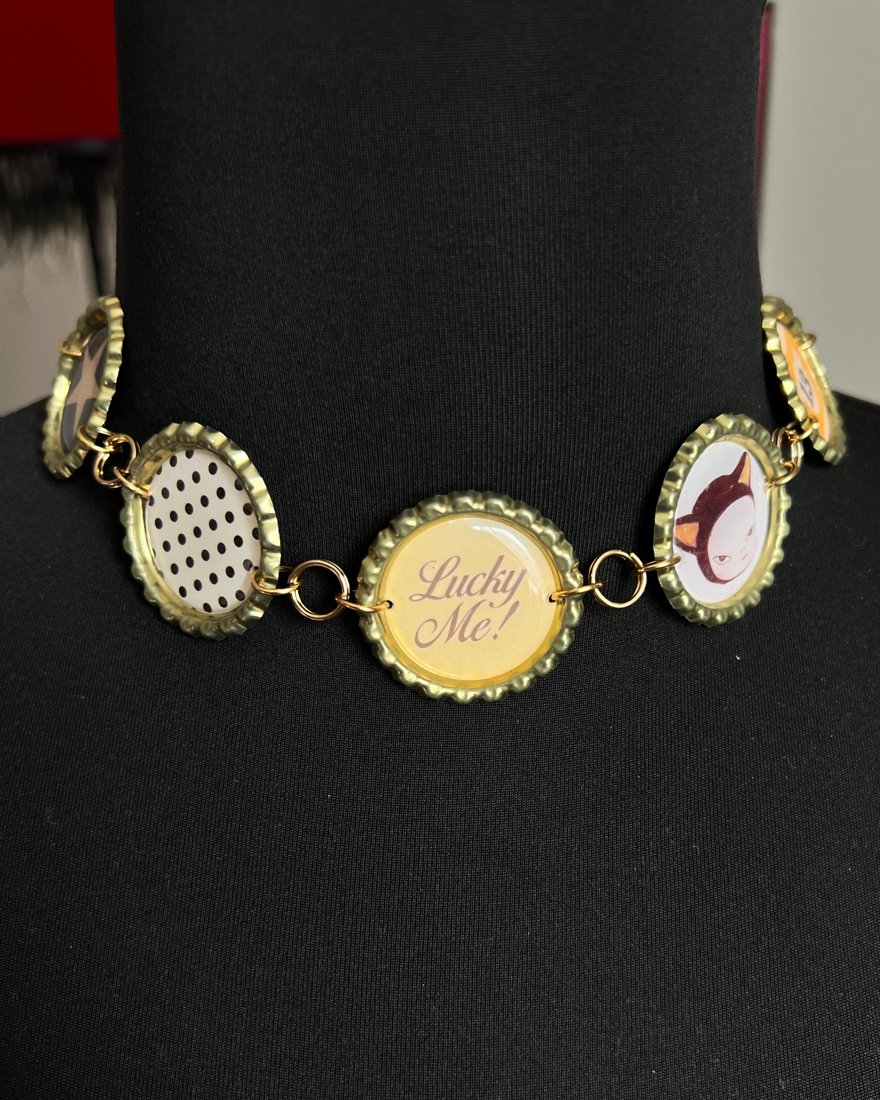 Necklace with bottle cap pendants on a black mannequin