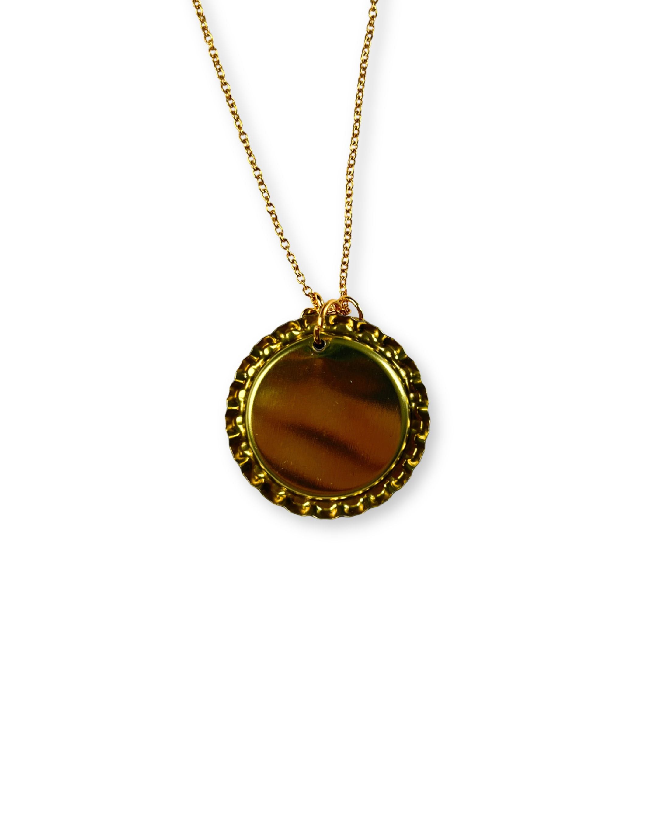 Gold necklace with a round pendant on a white background