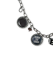 bag chain with various charms including a dice and 'Born to Shop' tag on a white background