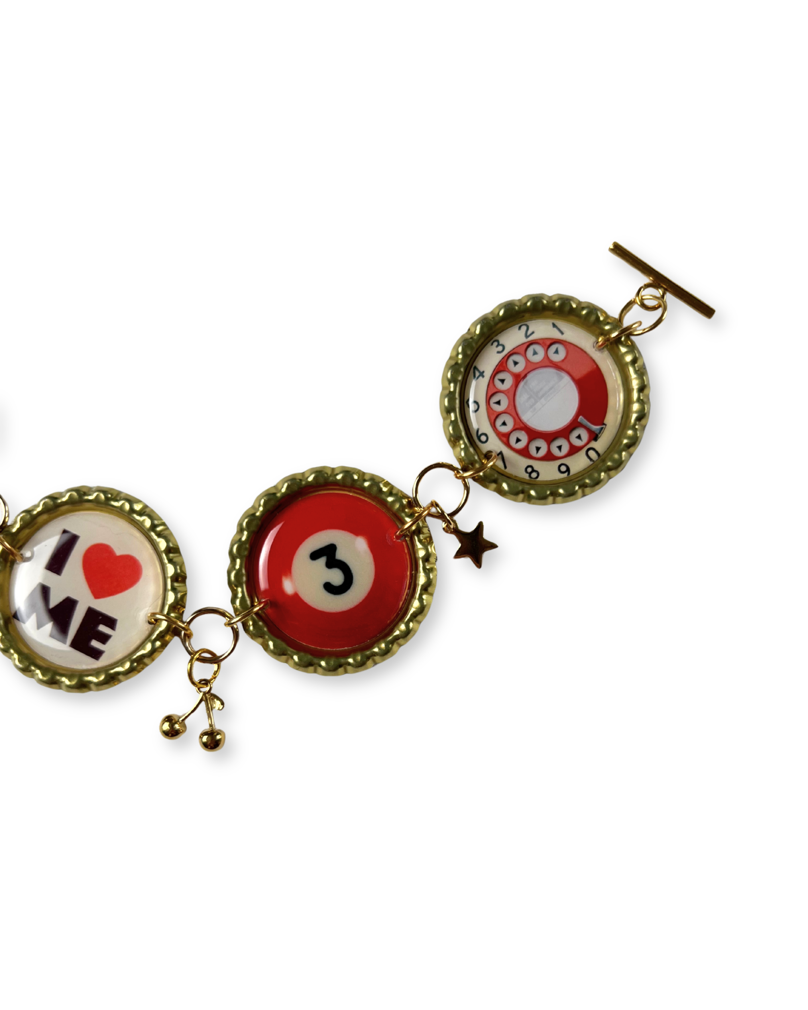 Three round charms with different designs on a white background