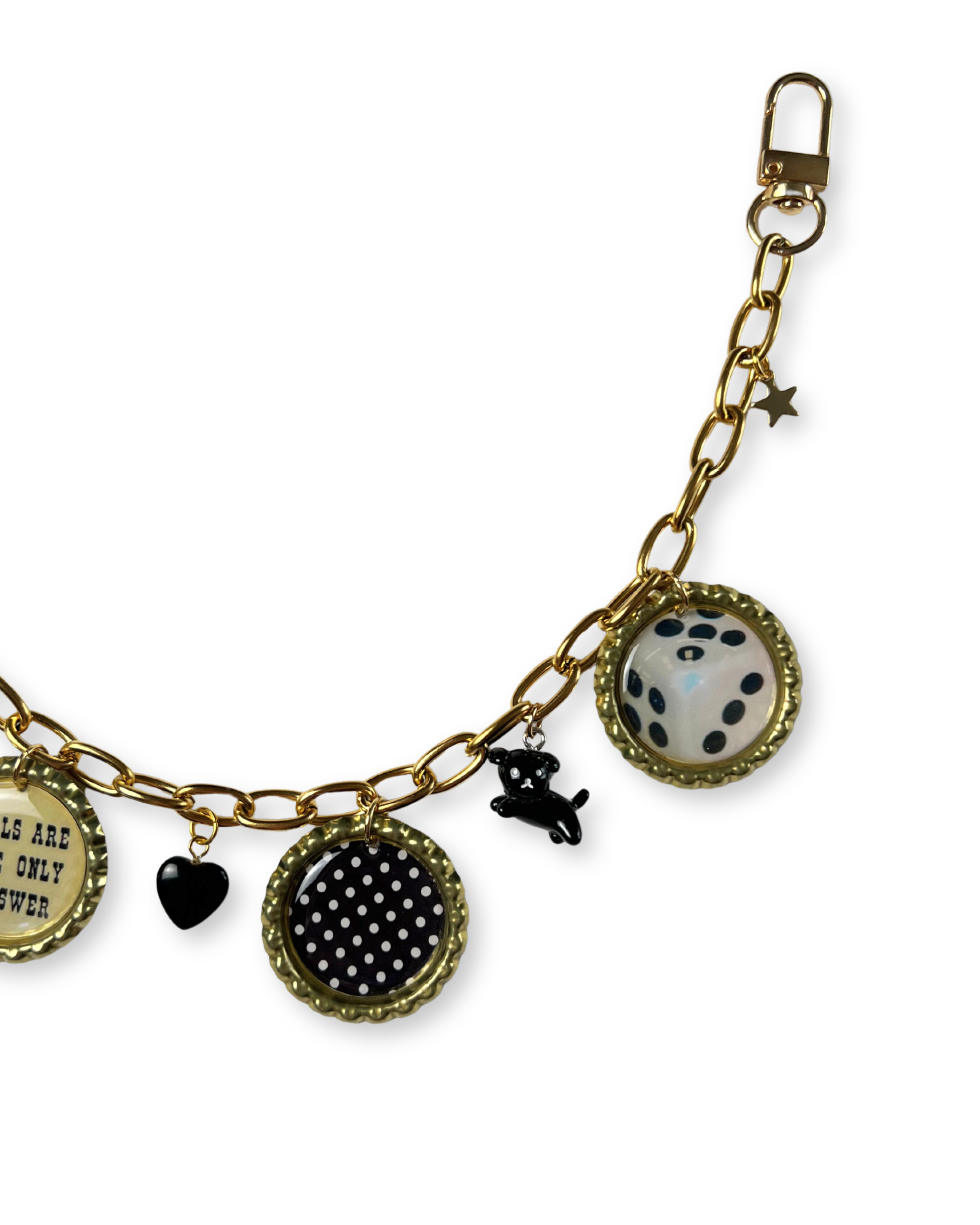 Gold charm bracelet with various charms on a white background