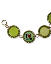 Bracelet with green and gold charms on a white background