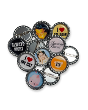 Collection of various buttons with different designs and text on a white background