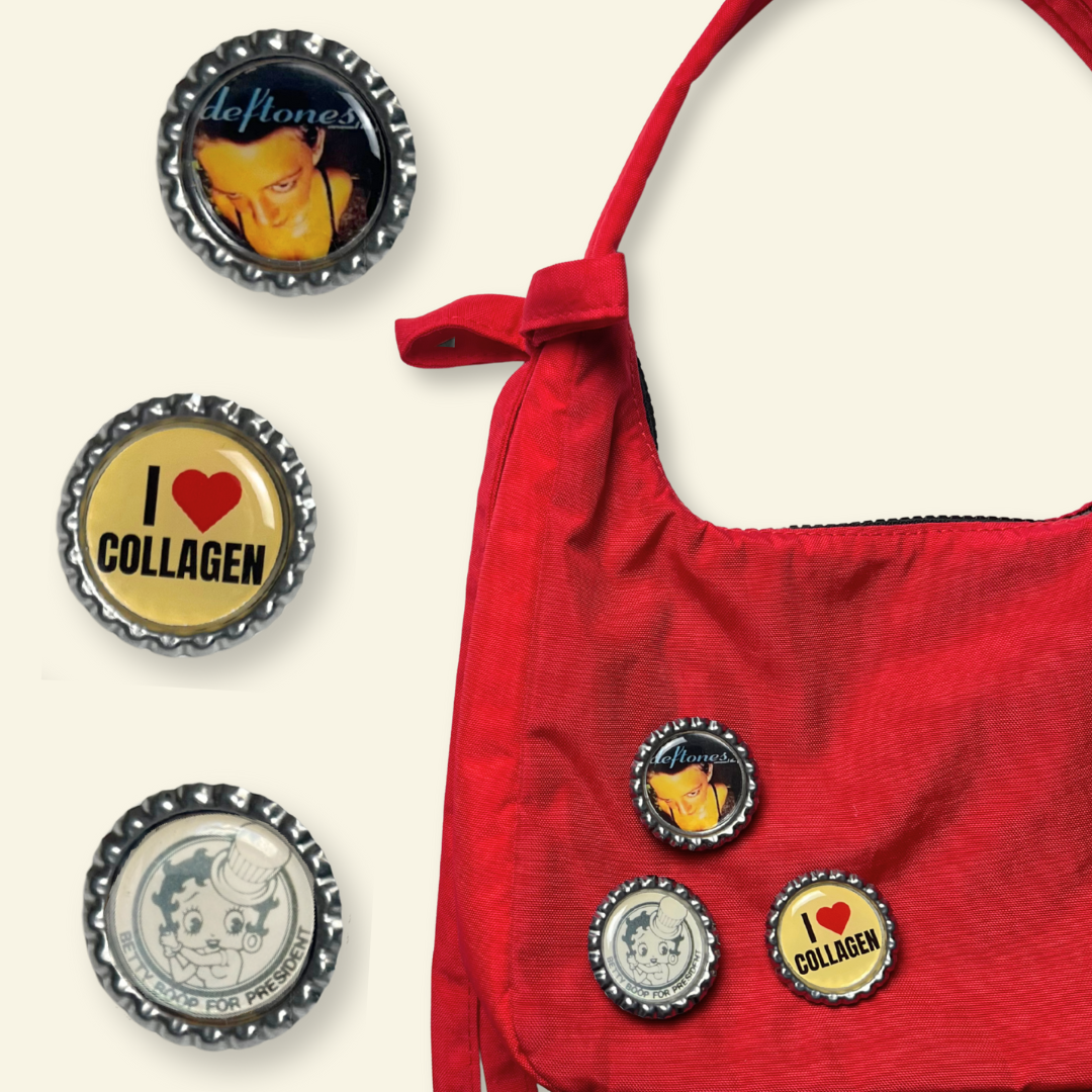 Red handbag with decorative bottle cap charms on a white background
