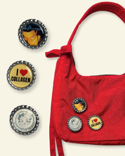 Red handbag with decorative bottle cap charms on a white background