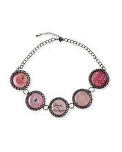 Necklace with pink circular charms on a white background