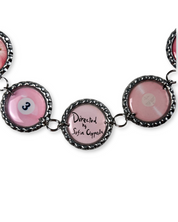 Bracelet with pink round charms and black text on a white background